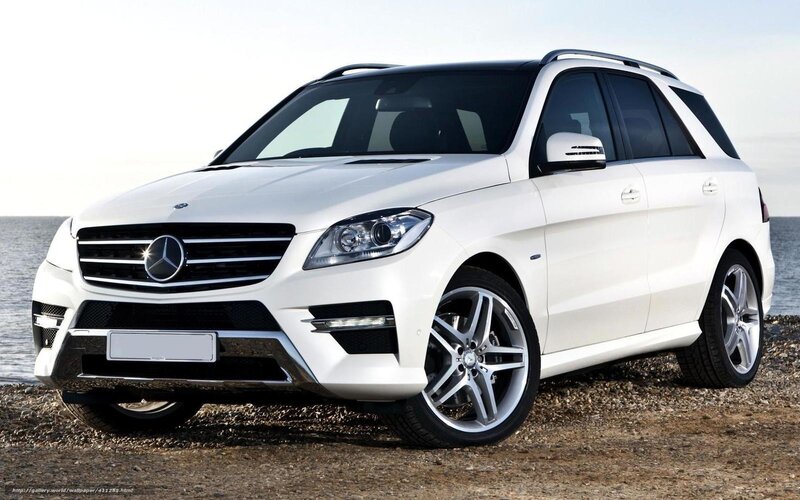 White Mercedes-Benz SUV by the sea