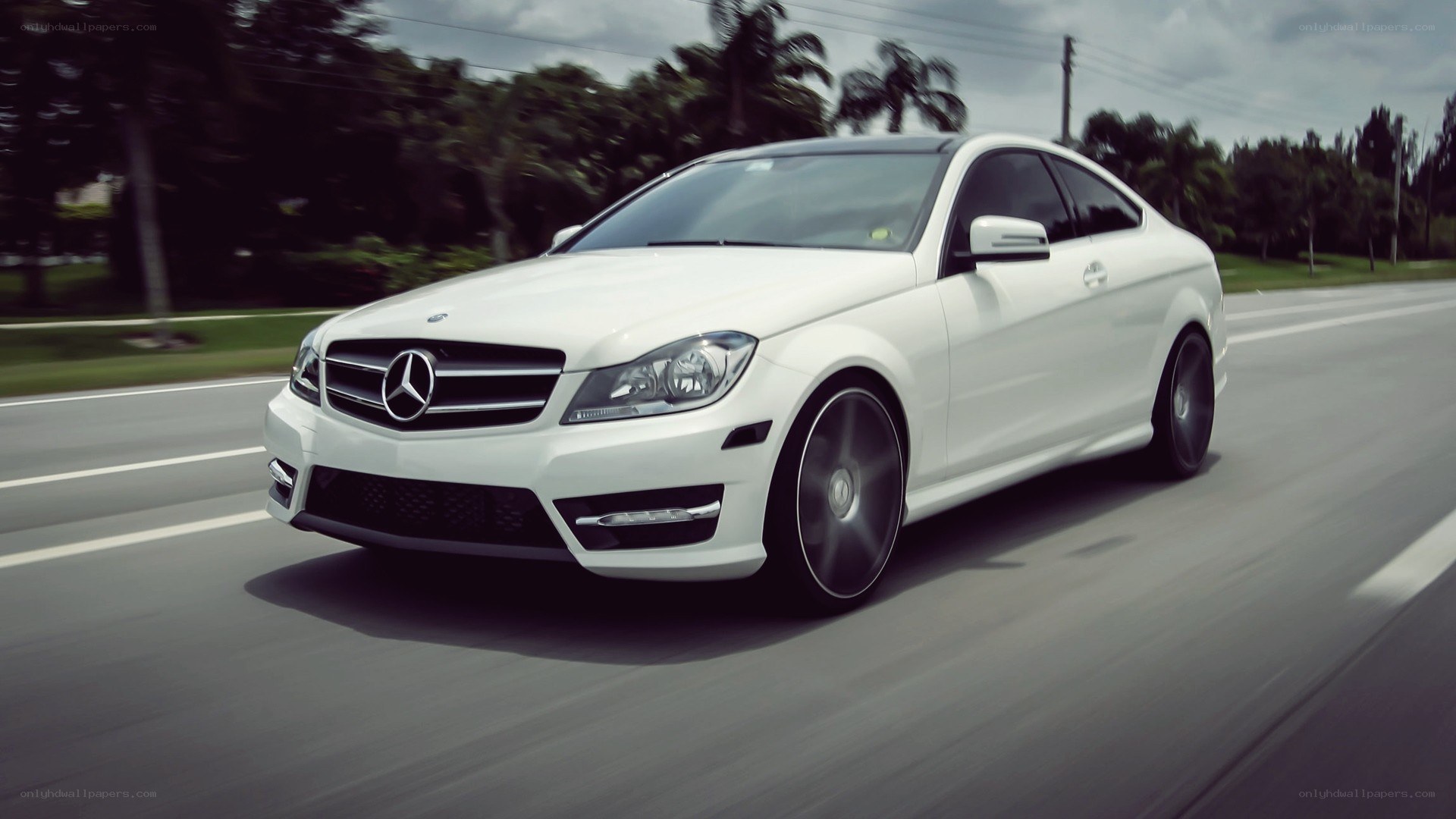 white mercedes c-class in motion