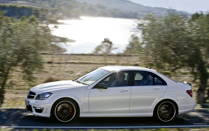 white mercedes c63 amg driving