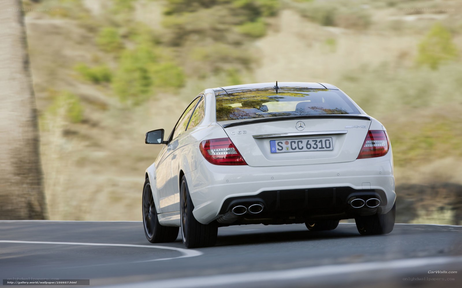 white mercedes c63 amg driving