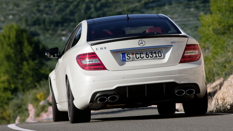 white mercedes c63 amg on road