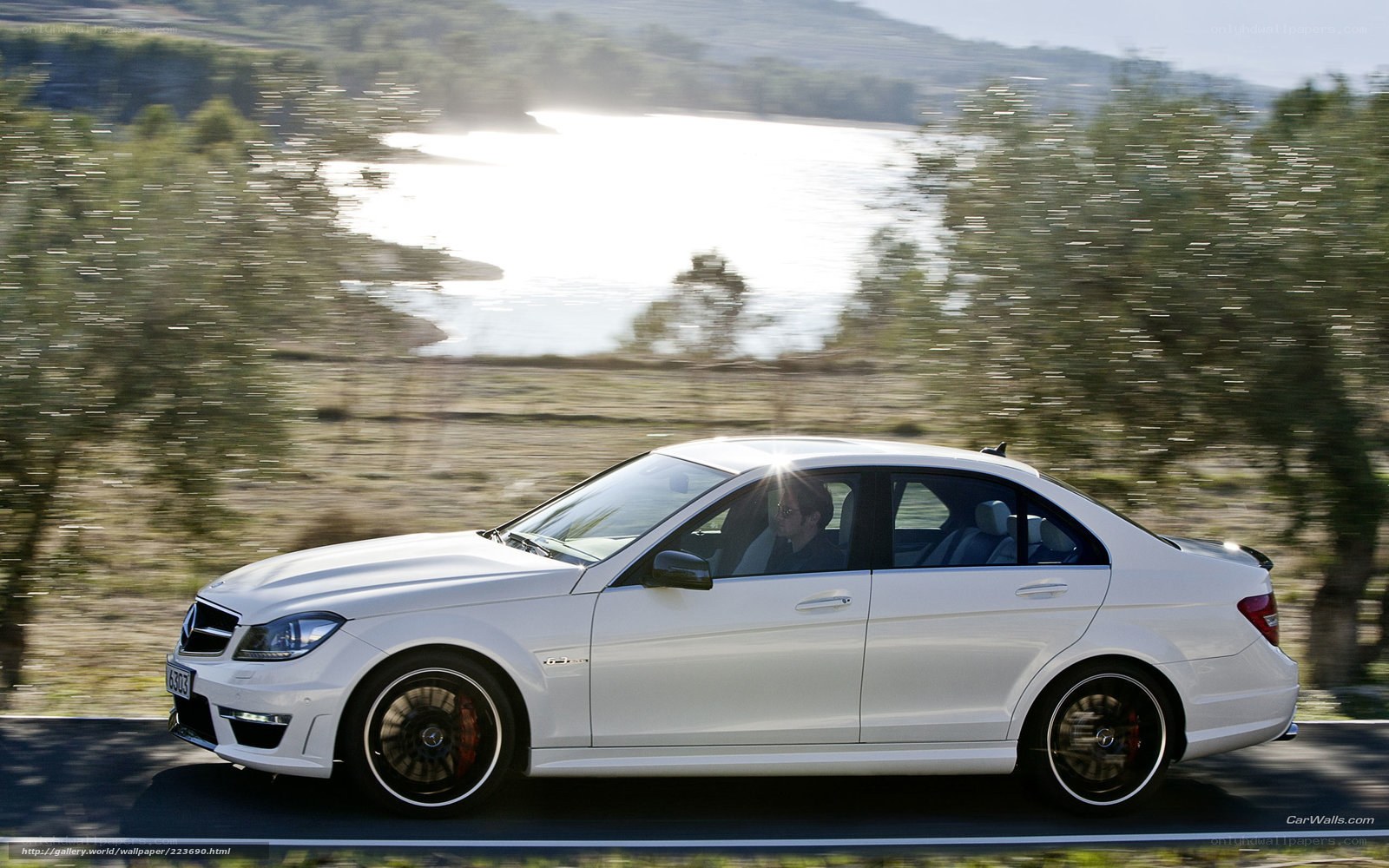white mercedes c63 amg on road