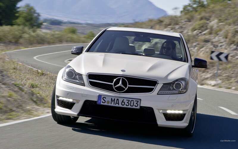 white mercedes c63 amg on winding road