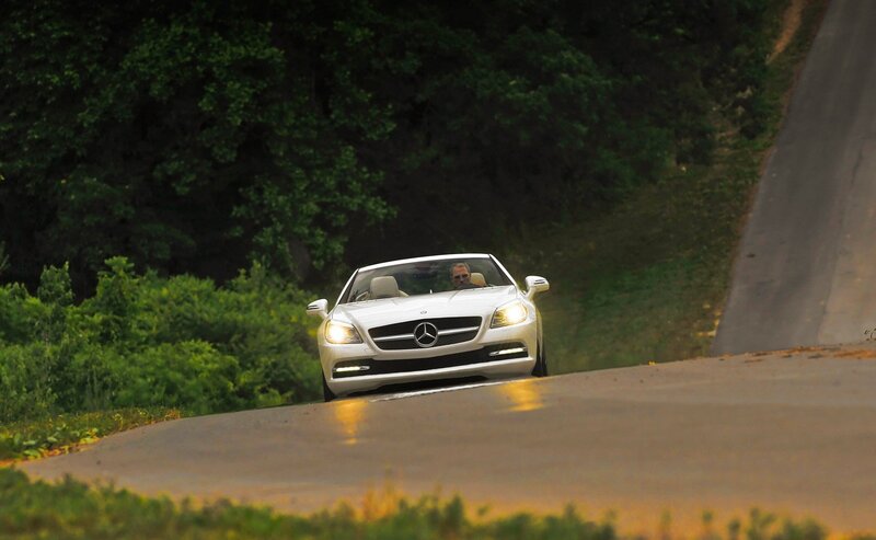 White Mercedes convertible on a road