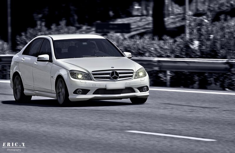 white mercedes driving on road