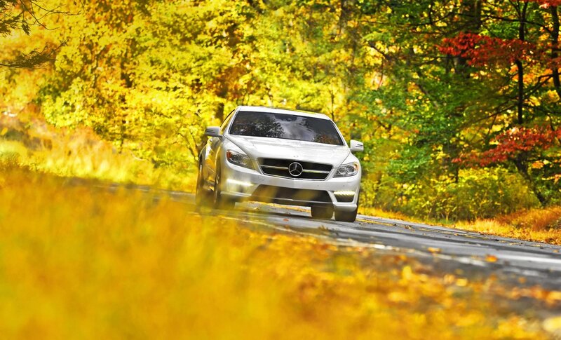 White Mercedes on autumn road