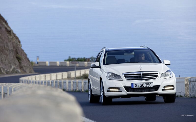 white mercedes on coastal road