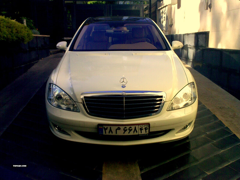 white mercedes parked on driveway