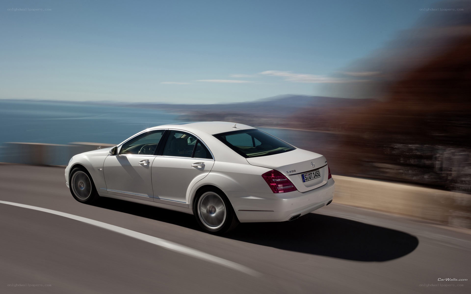 white mercedes s400 driving