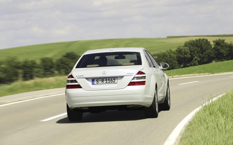 white mercedes s400 hybrid driving