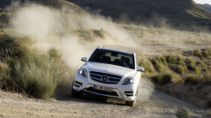 White Mercedes SUV on dirt road