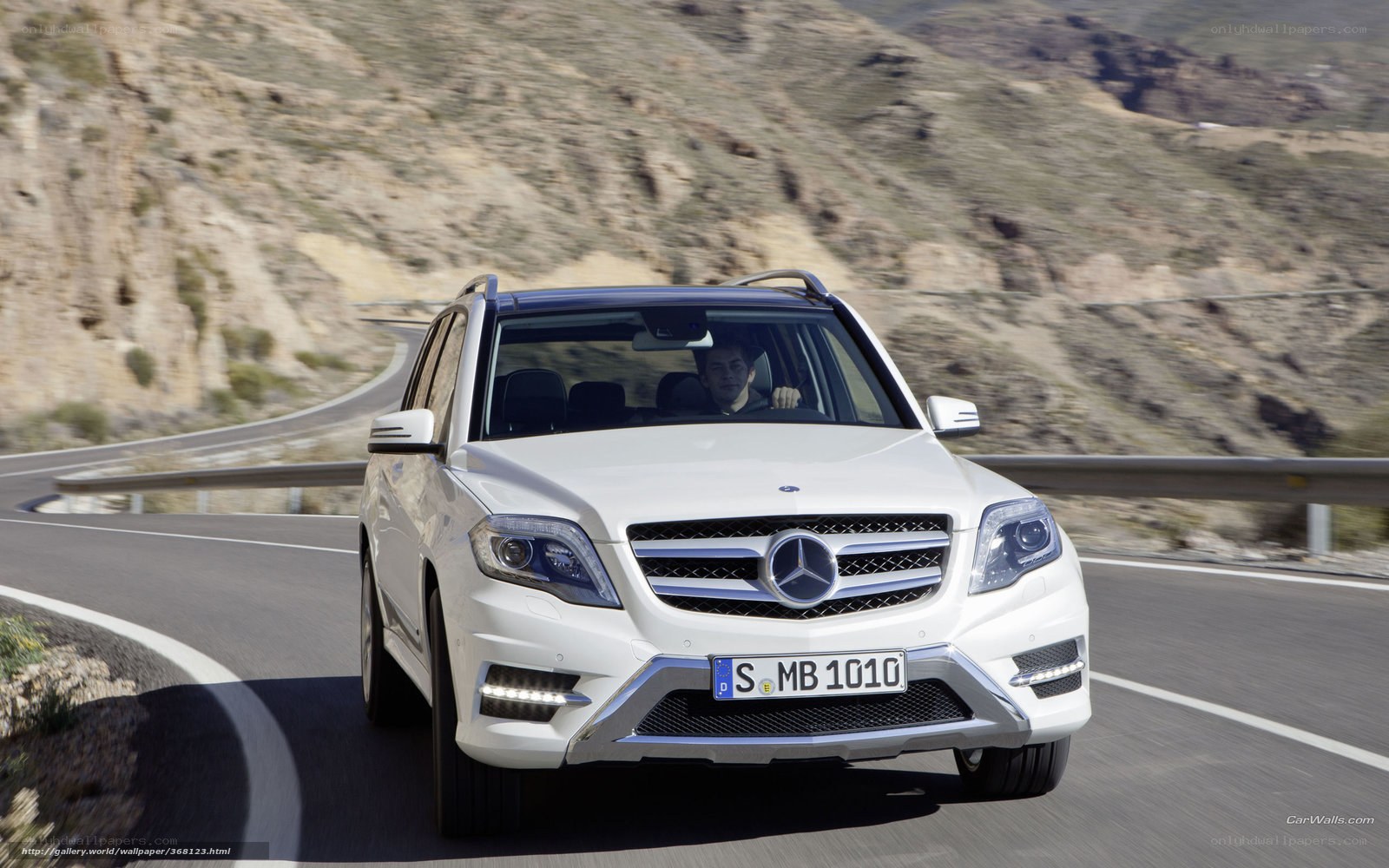 white mercedes suv on mountain road