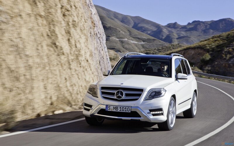 white mercedes suv on mountain road