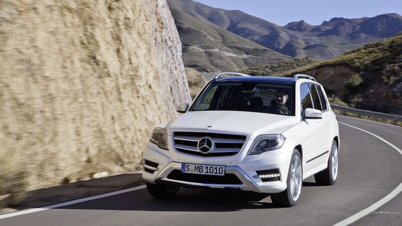 white mercedes suv on mountain road