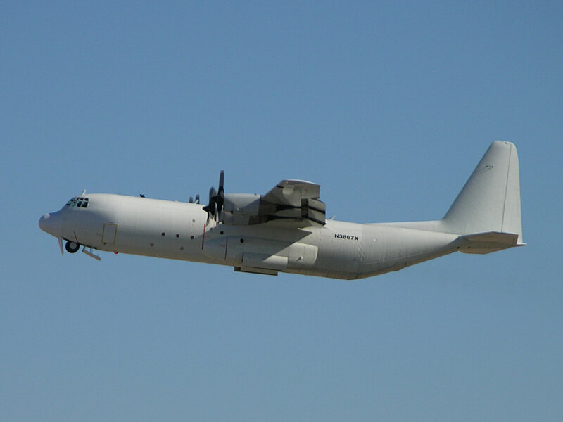 White military transport plane in flight