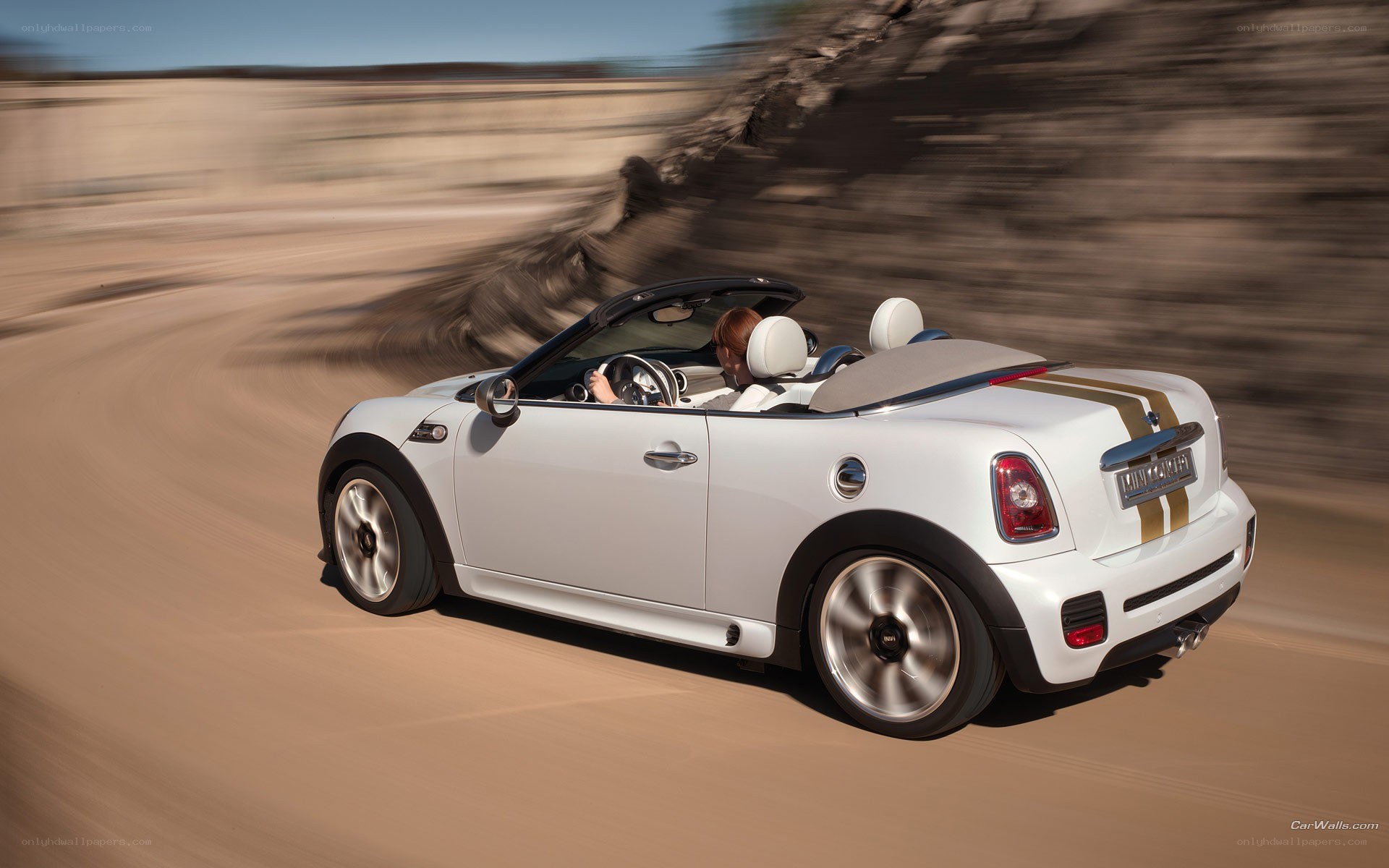 white mini convertible driving