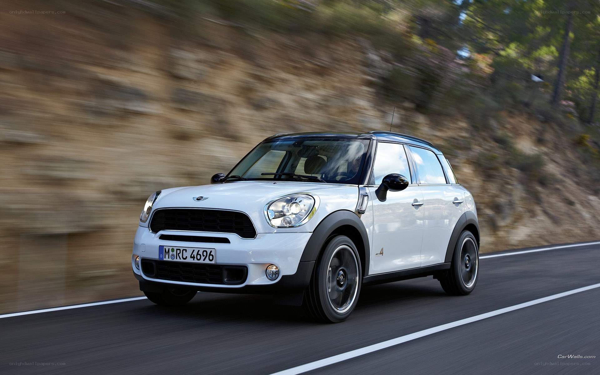 white mini cooper driving on road