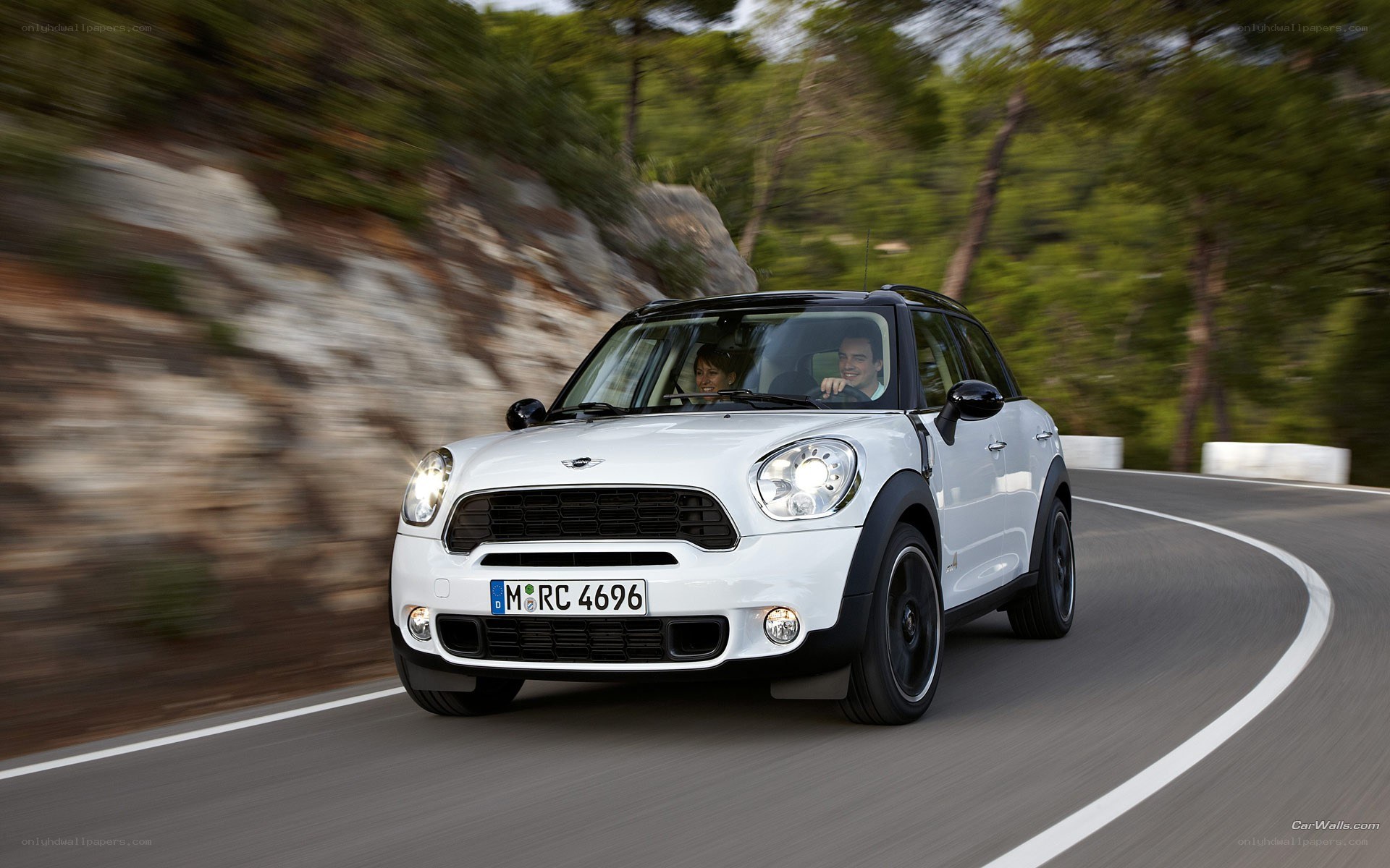 white mini cooper driving on road