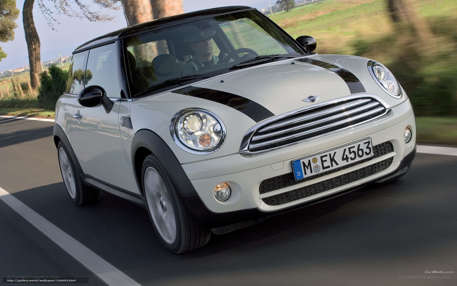 White MINI Cooper driving on road