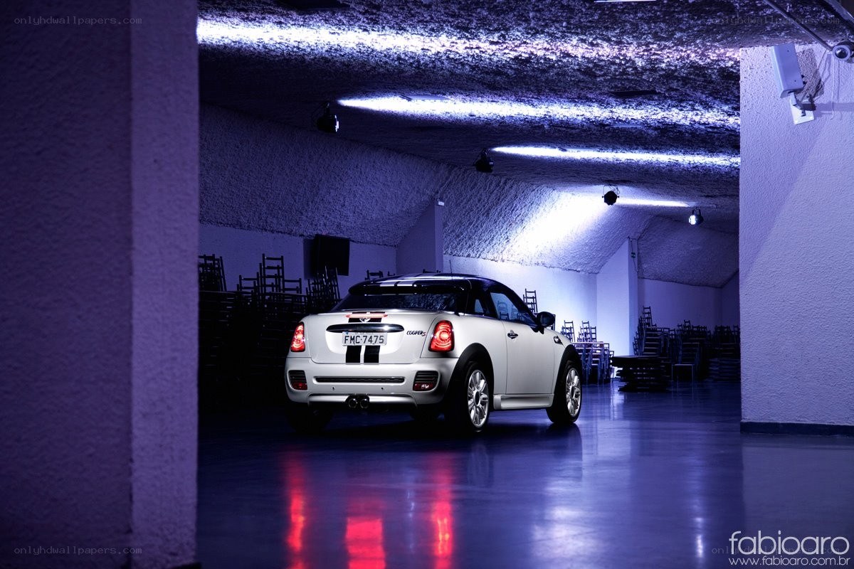 White Mini Cooper in a dimly lit hall