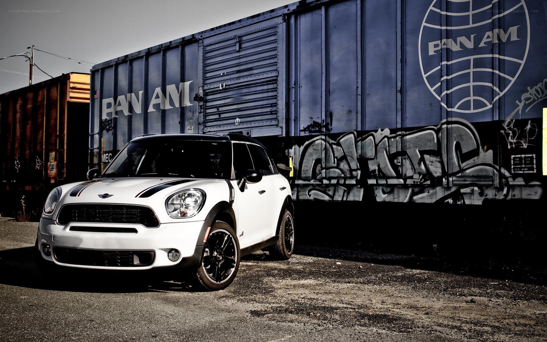 White Mini Cooper parked by train