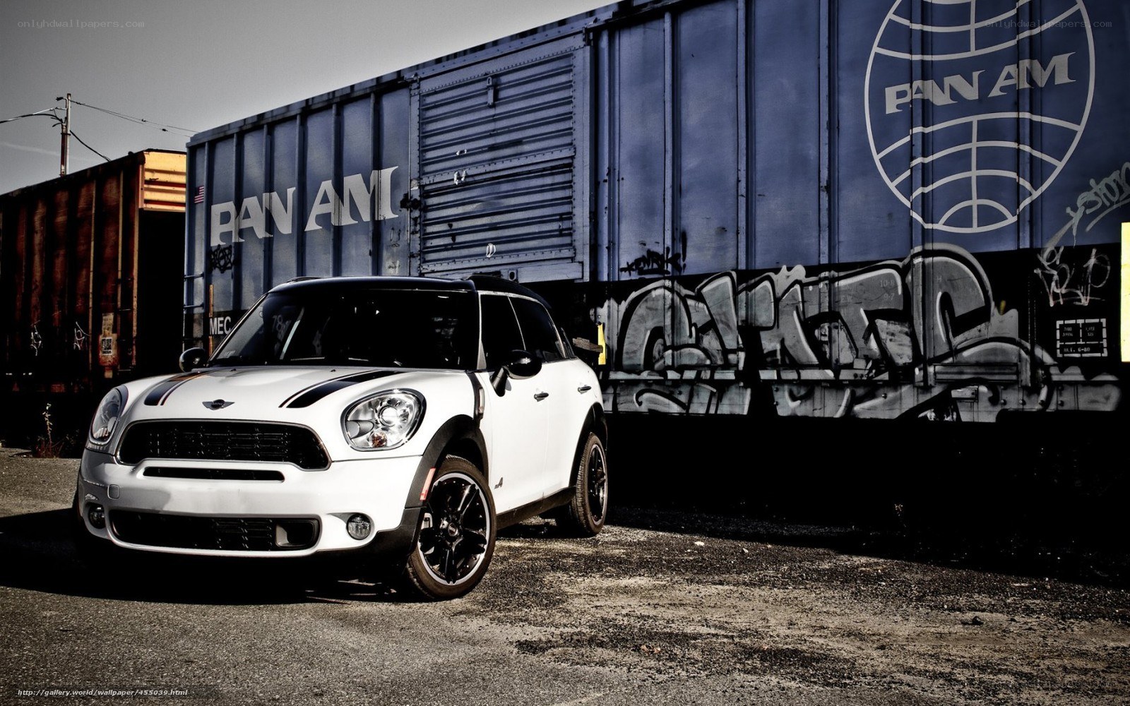 White Mini Cooper parked by train