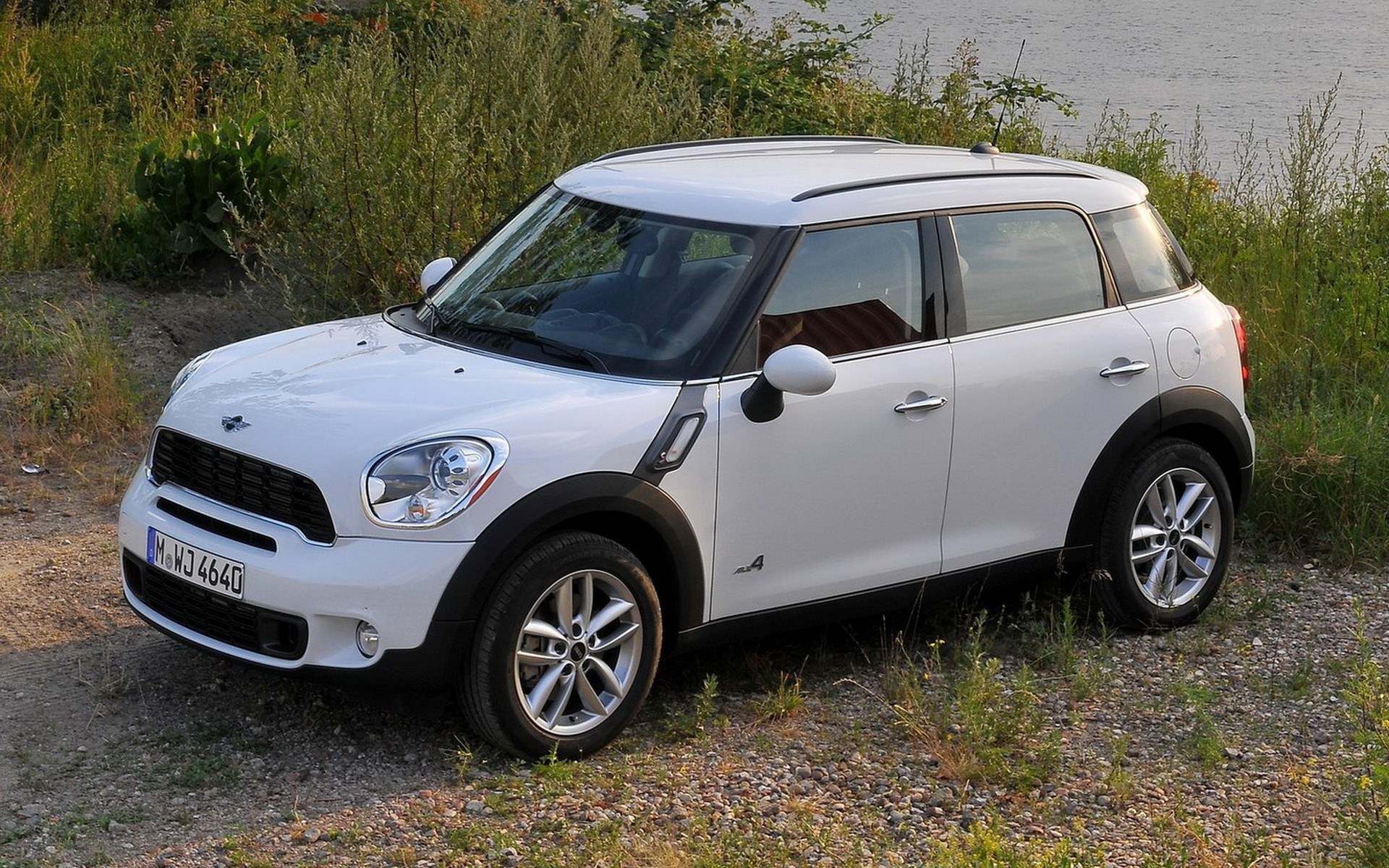 white mini cooper parked by water
