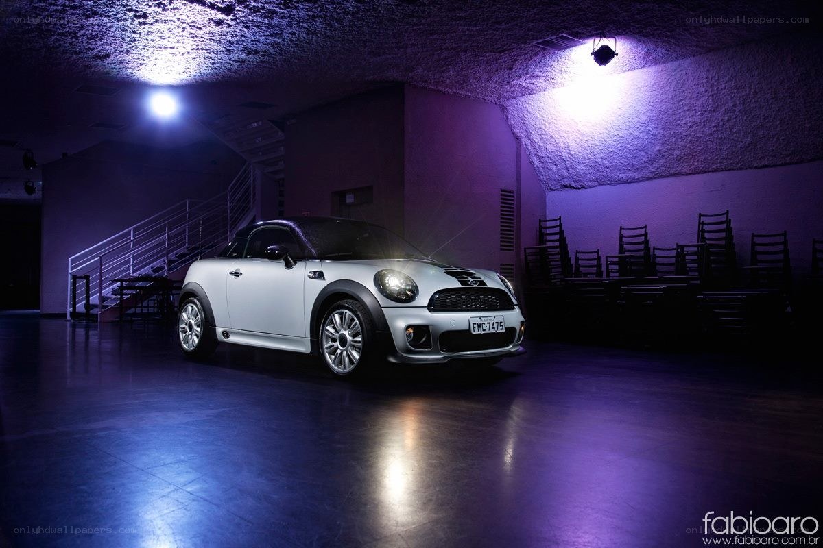 White MINI Cooper parked in dark room