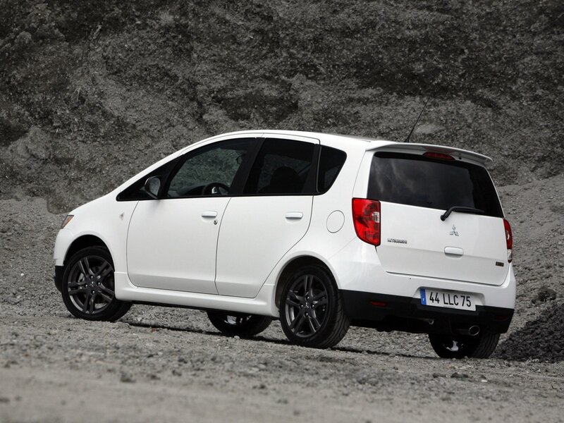 white mitsubishi car on gravel