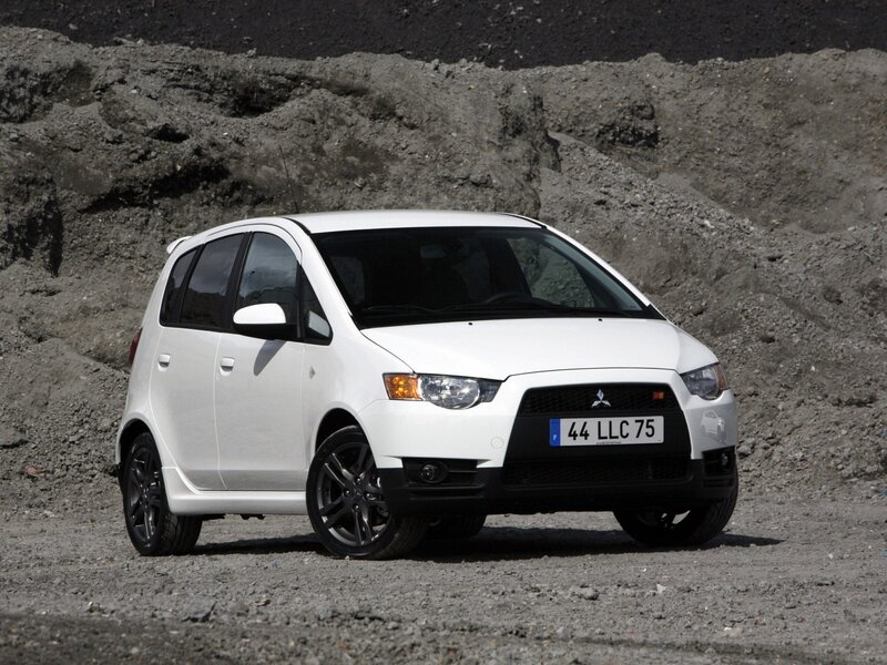 white mitsubishi car on gravel