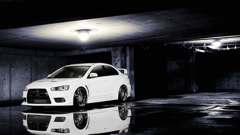 white mitsubishi in parking garage
