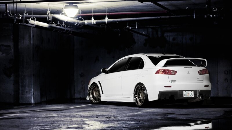 white mitsubishi in parking garage