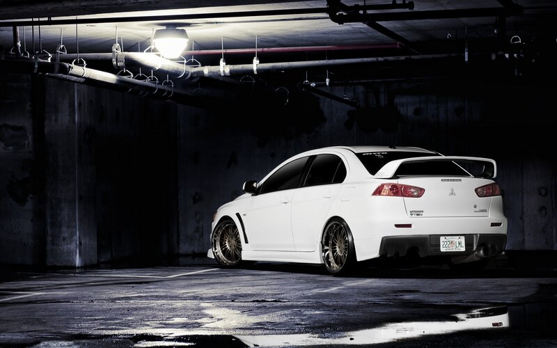 White Mitsubishi in parking garage