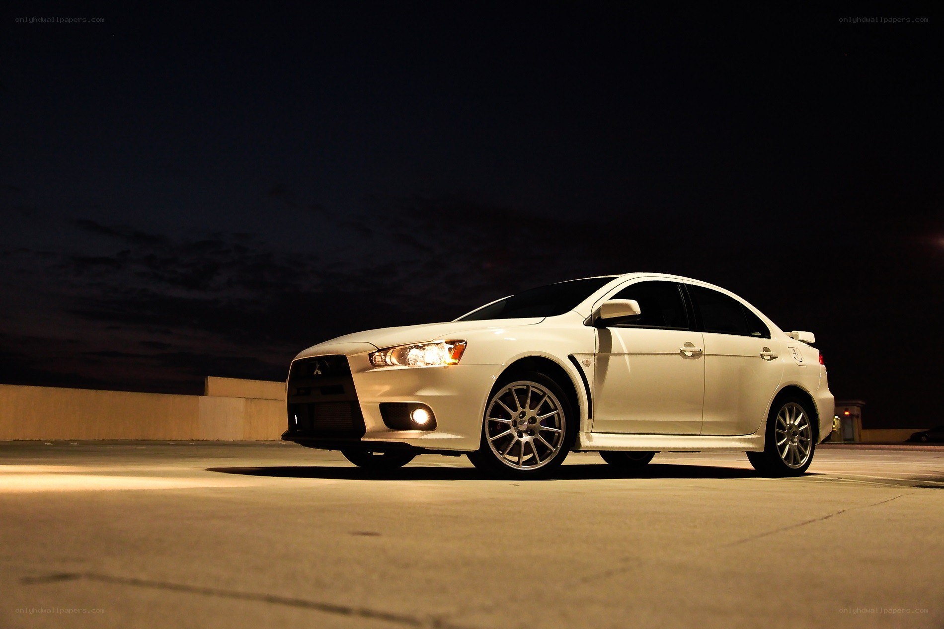 White Mitsubishi Lancer at night
