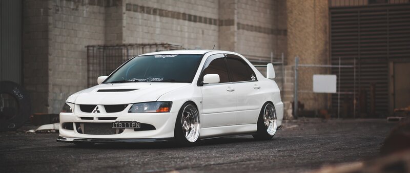 White Mitsubishi Lancer — Dramatic, Photograph, Car, Building, Tire