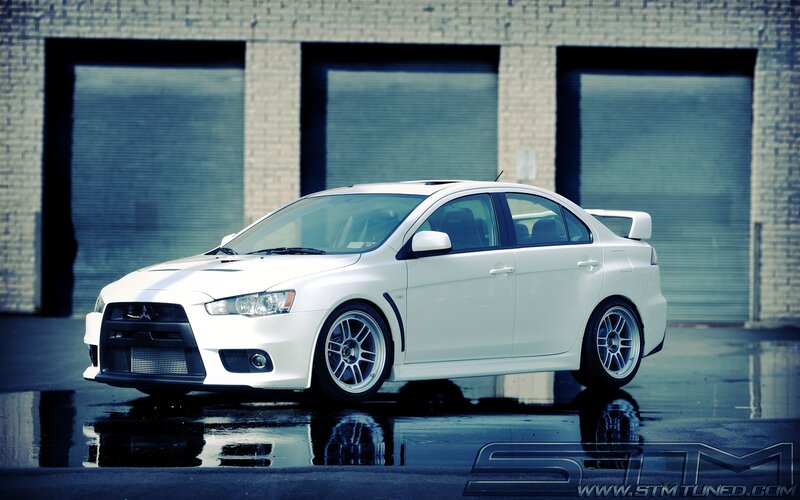 White Mitsubishi Lancer — Dramatic, Photograph, Car, Building, Wet Pavement