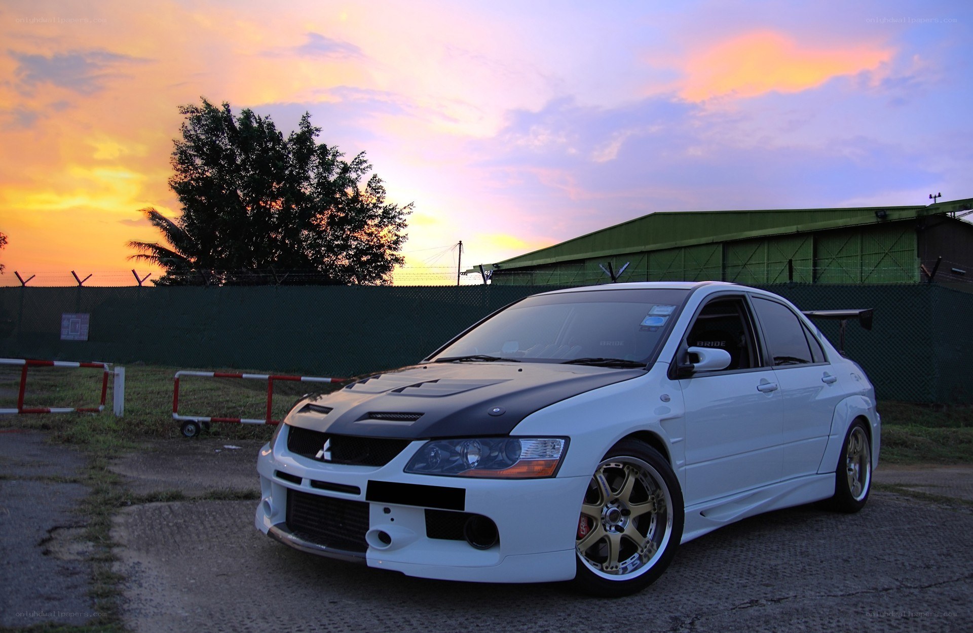 white mitsubishi lancer evo at sunset
