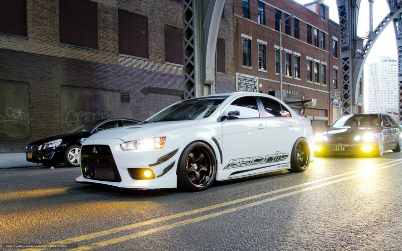 white mitsubishi lancer evo on city street