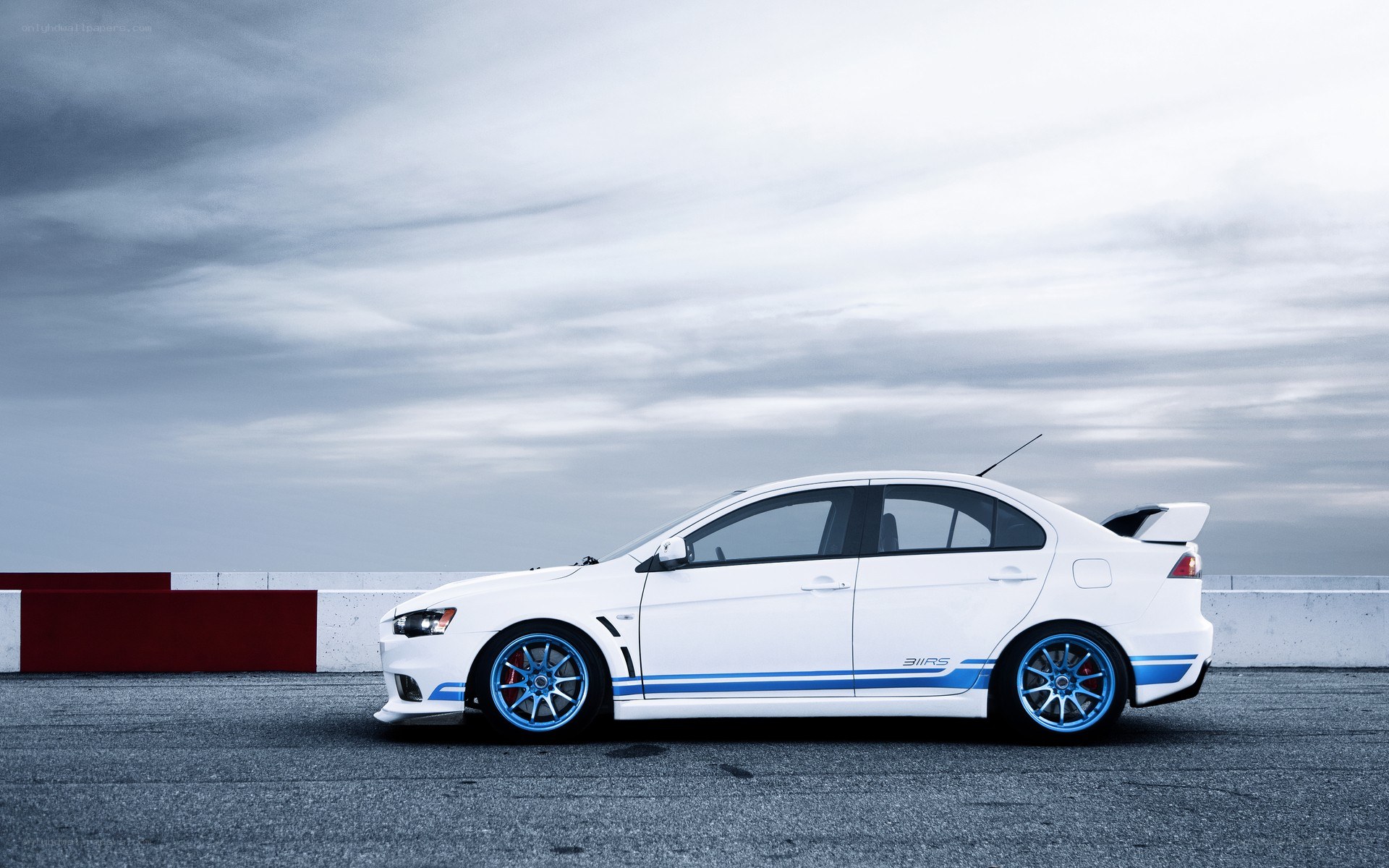 white mitsubishi lancer evo on track