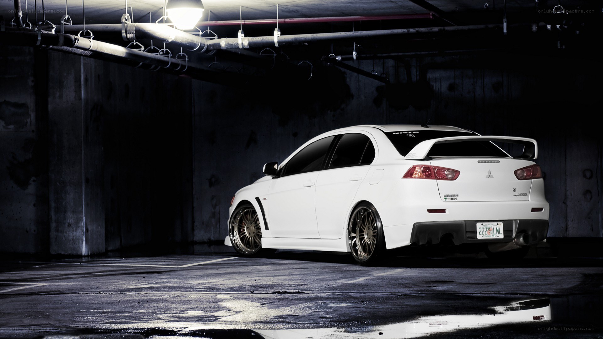 white mitsubishi lancer in garage