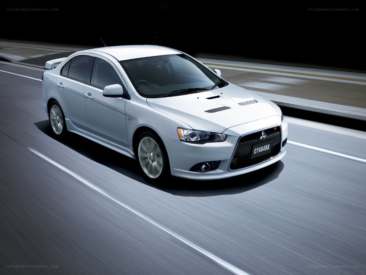 White Mitsubishi Lancer in motion