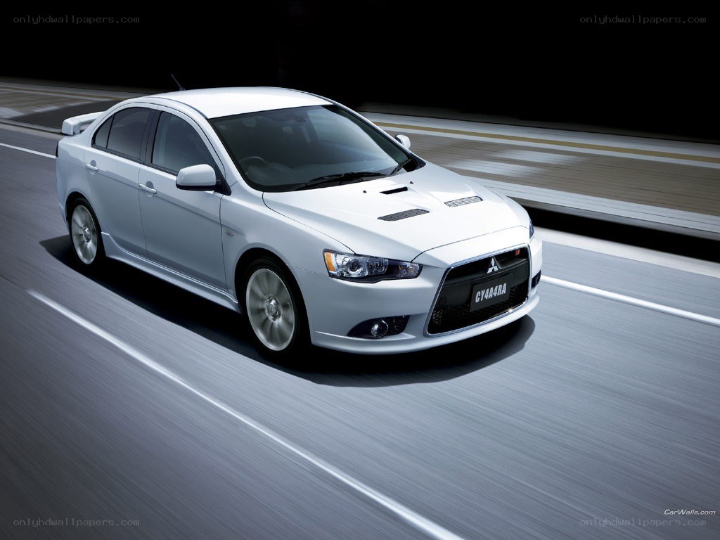 white mitsubishi lancer in motion
