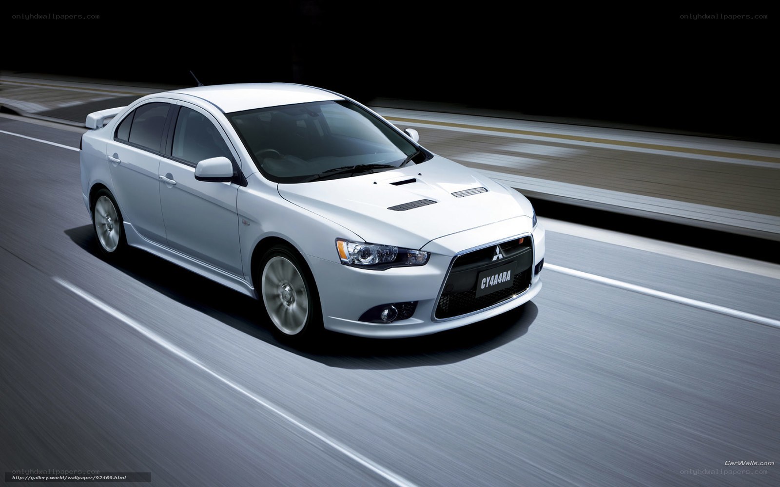 White Mitsubishi Lancer in motion