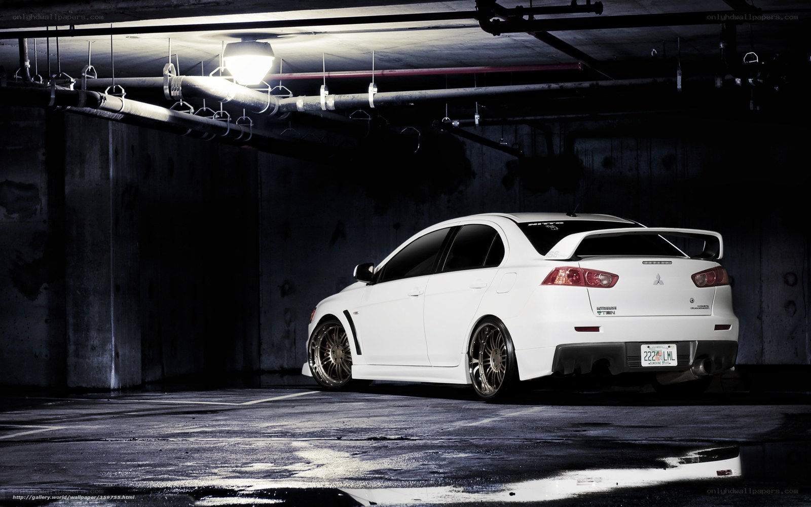 White Mitsubishi Lancer in parking garage