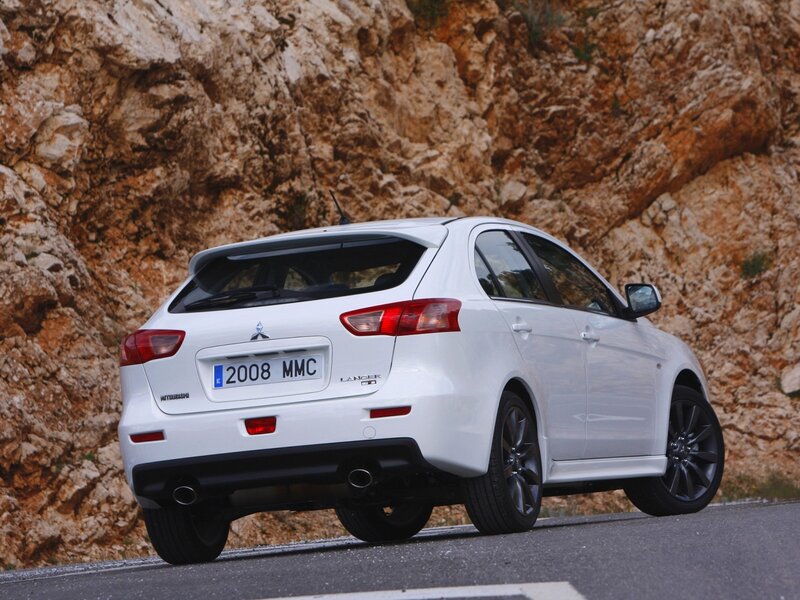 White Mitsubishi Lancer on a mountain road