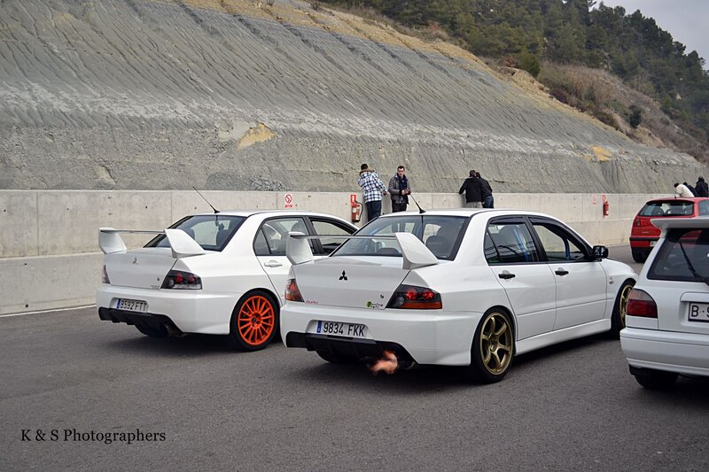 White Mitsubishi Lancers at a track