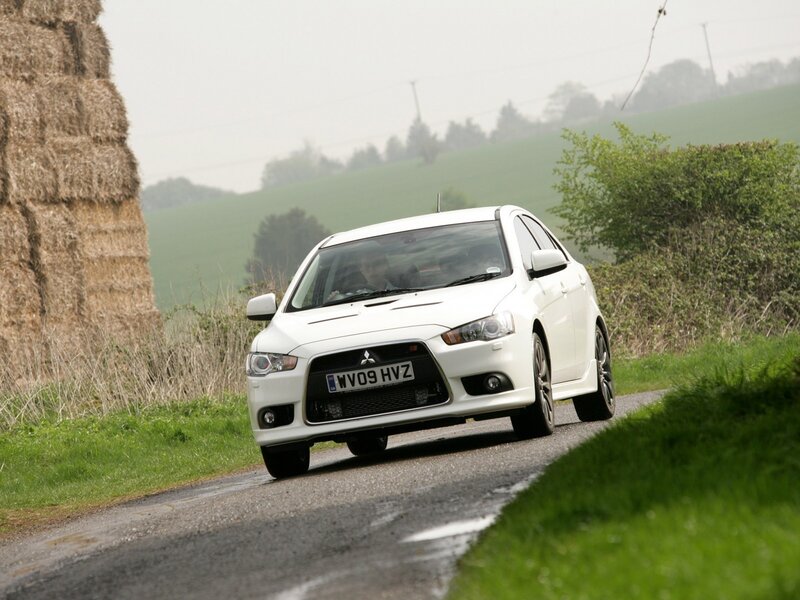 white mitsubishi on country road