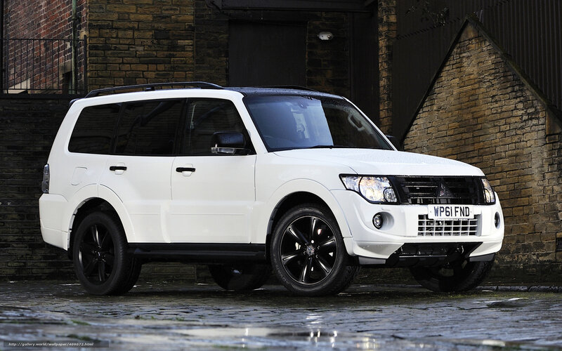 white mitsubishi suv on cobblestones