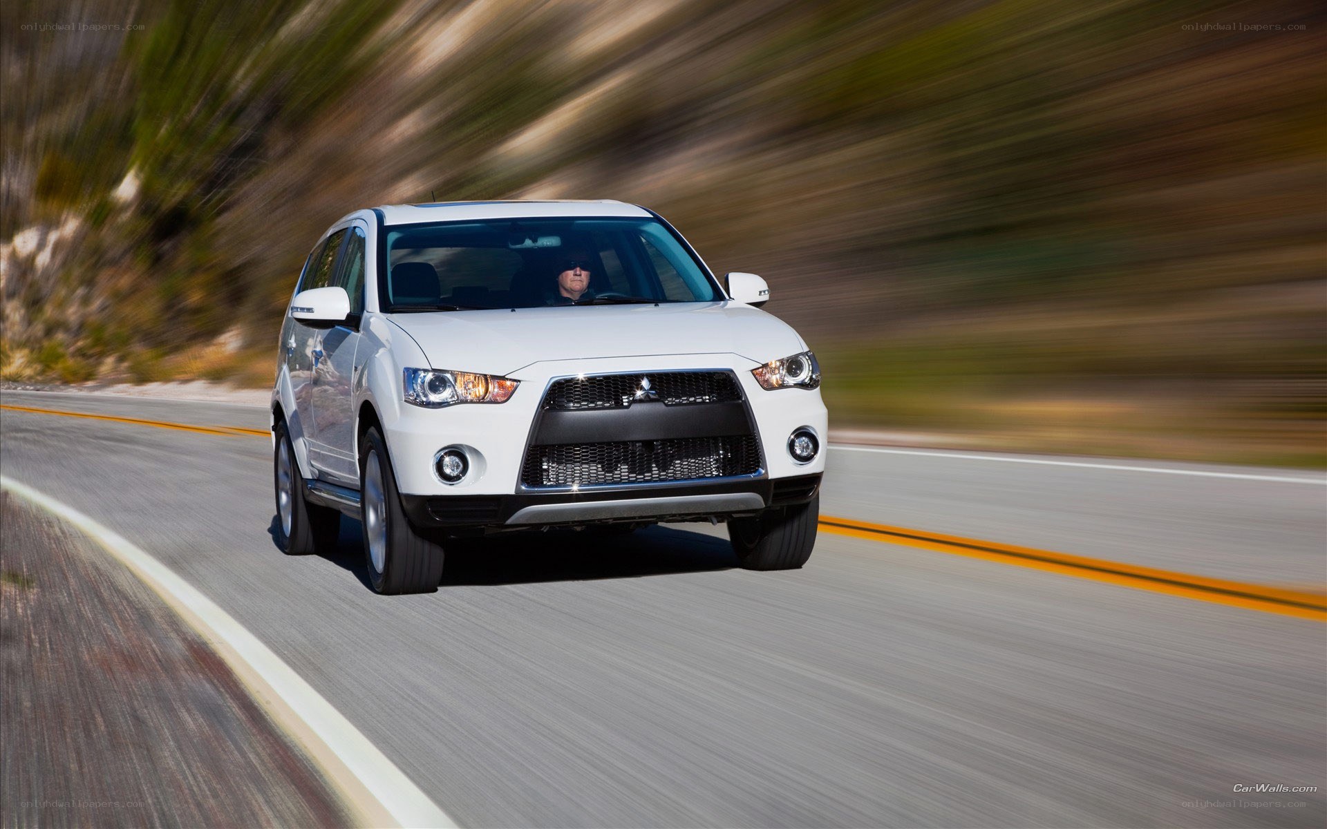 white mitsubishi suv on road