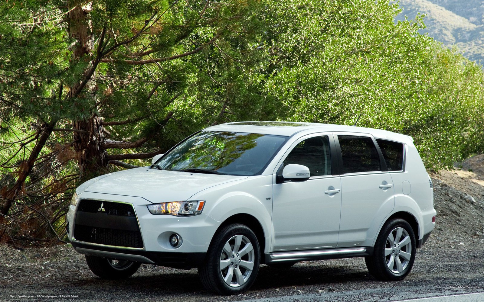 white mitsubishi suv on road